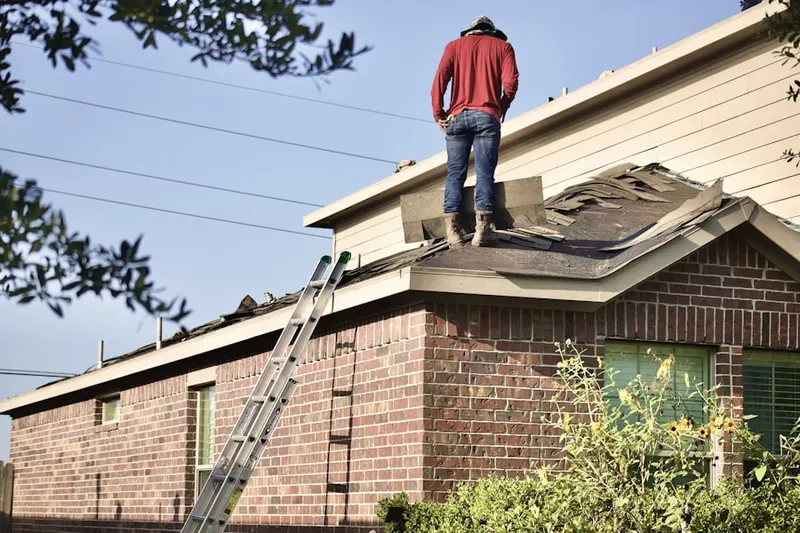 Professional roofer working on a residential roof in Ducat Town